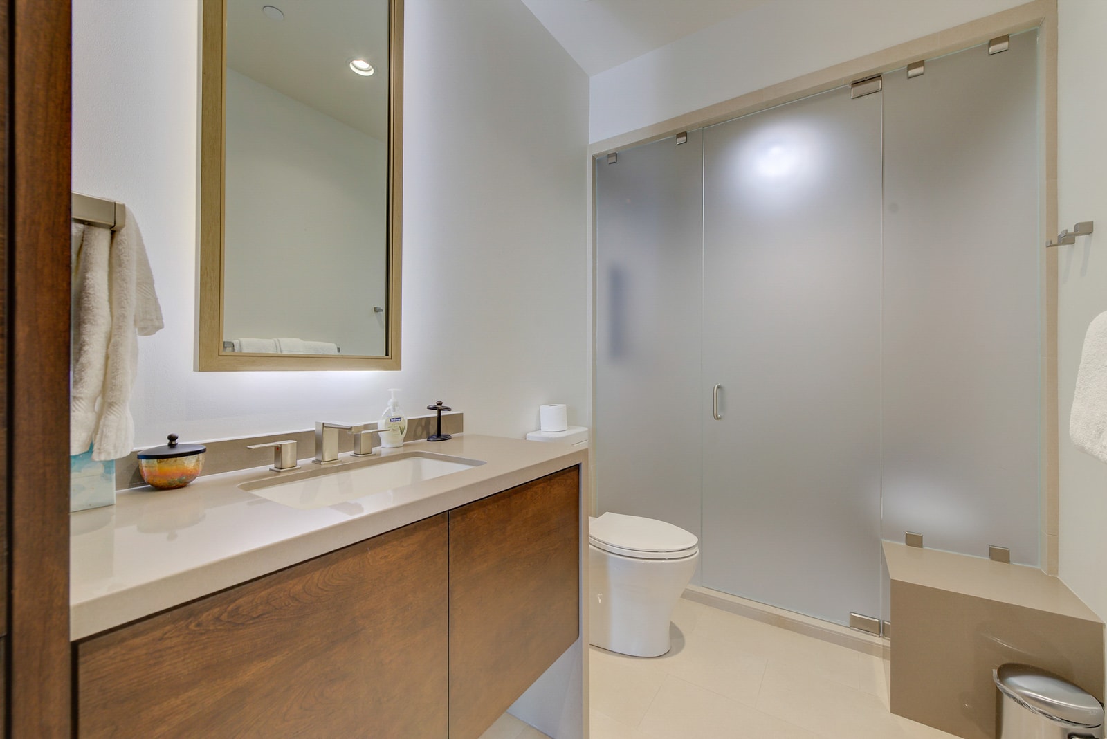 Full guest bath with step-in shower and sleek vanity.