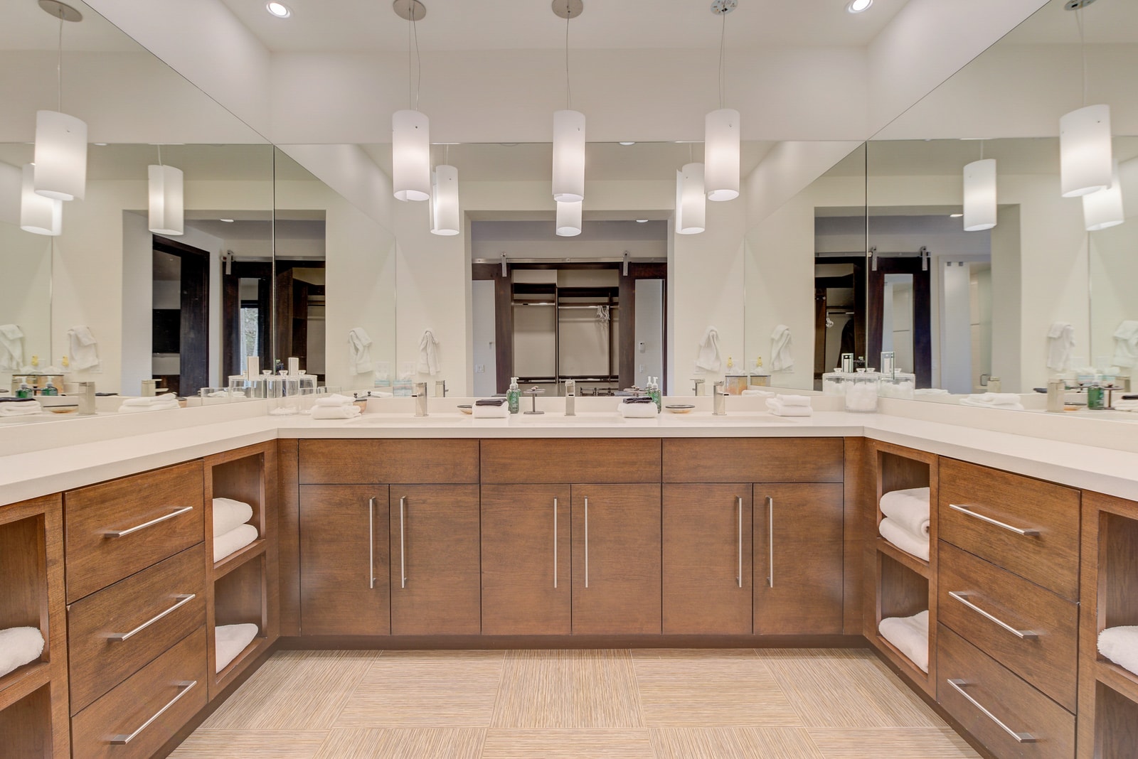 Custom-designed bath with two vanities, two showers, and multiple lavatories.