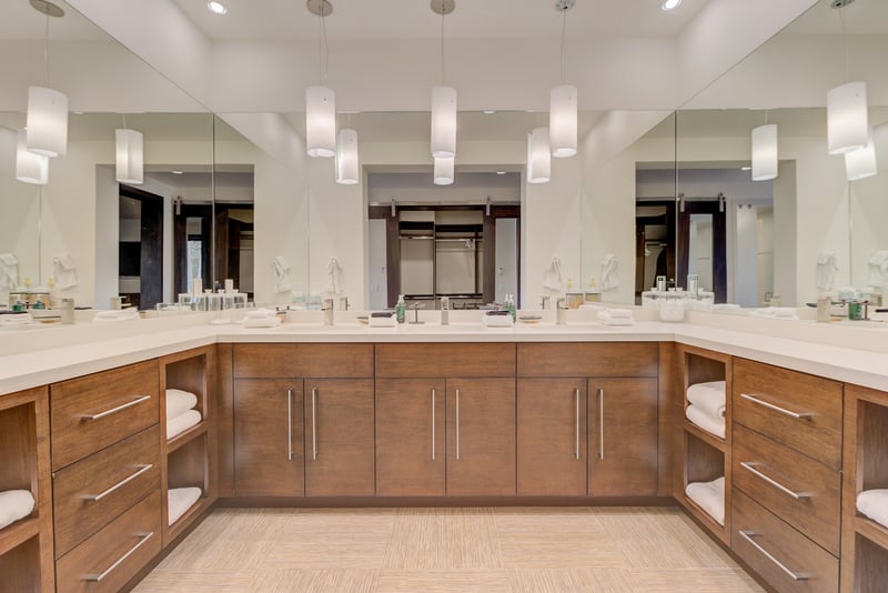 Custom-designed bath with two vanities, two showers, and multiple lavatories.
