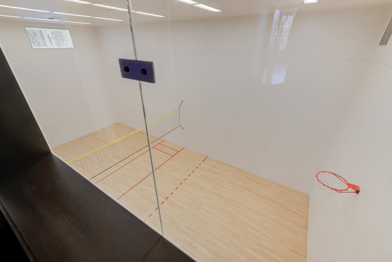 Indoor sport court with hoops, high ceilings, and room to play.