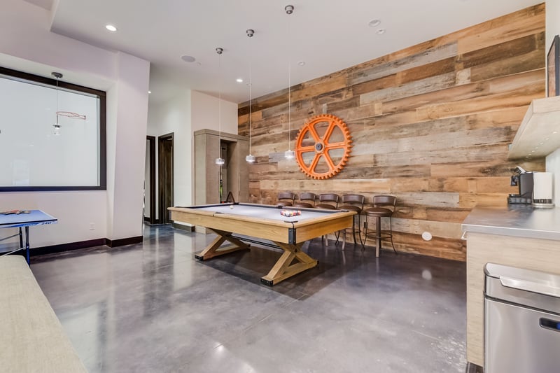 Rustic walls and leather seating add warmth to this lower-level hangout.