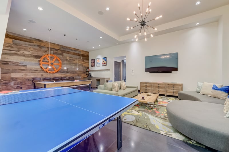 Game night is easy with ping pong, cozy couches, and bar seating in one space.