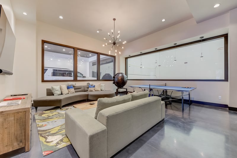 Lounge, read, or connect in this bright family room with wood accents and style.