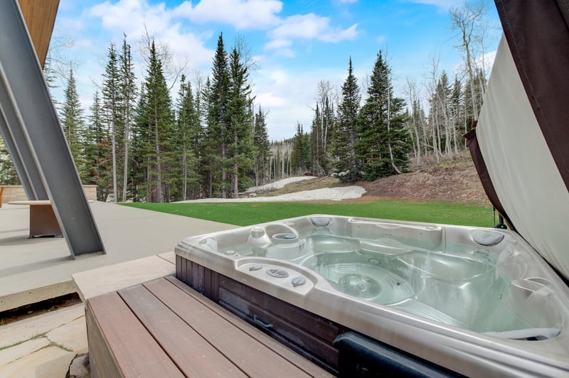 Private hot tub with forest views invites you to soak under the stars year-round.