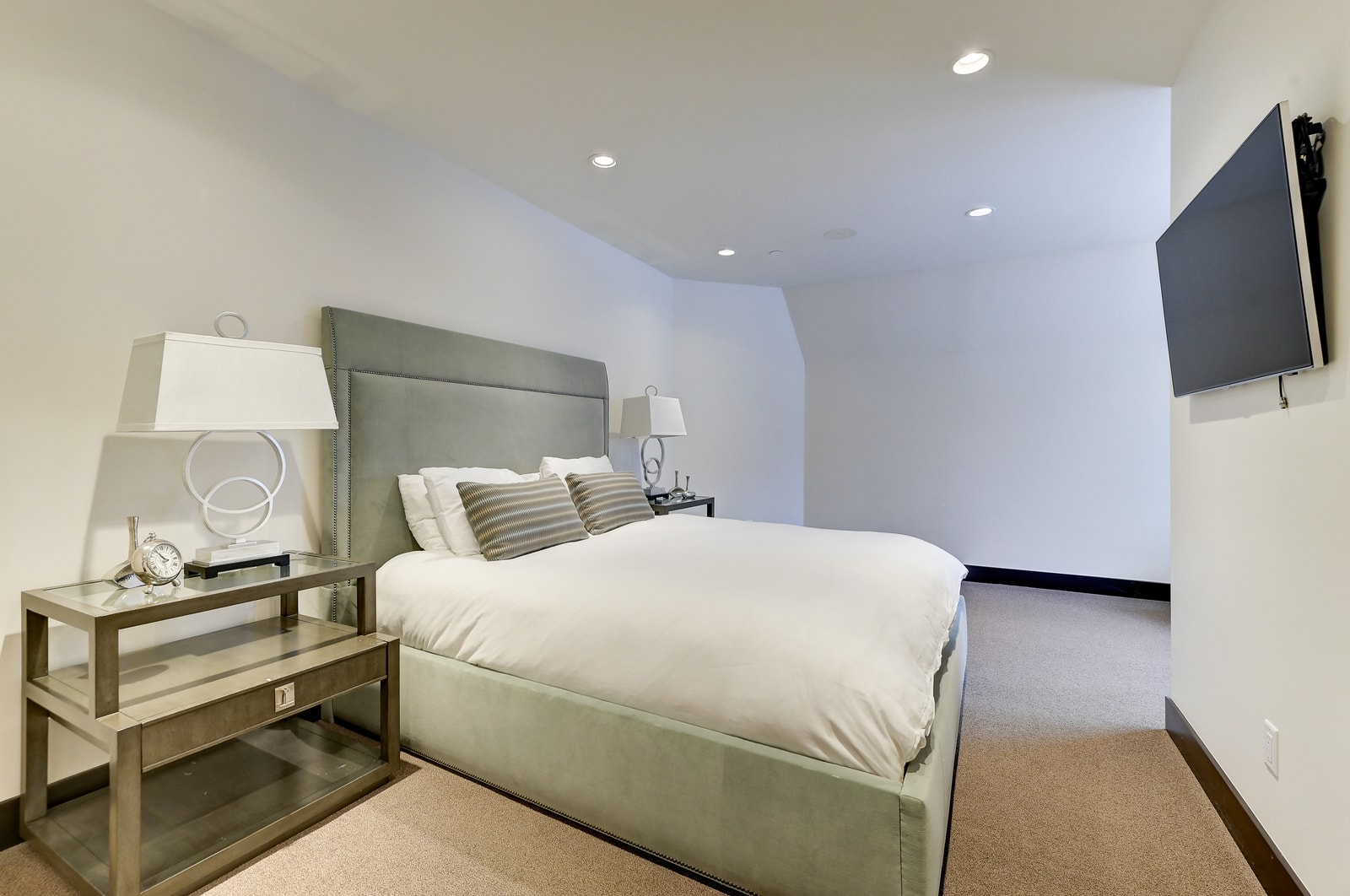 King room with TV, seating, and easy access to upper-level baths.