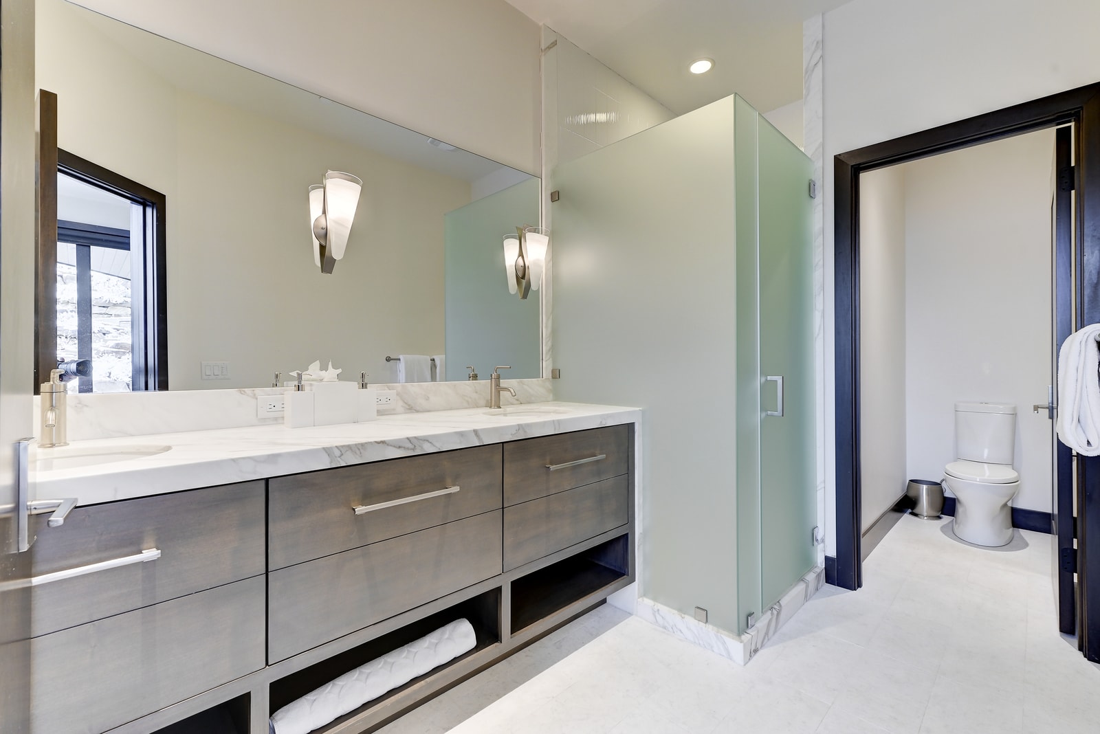 Ensuite bath with custom dual vanity and walk-in shower.