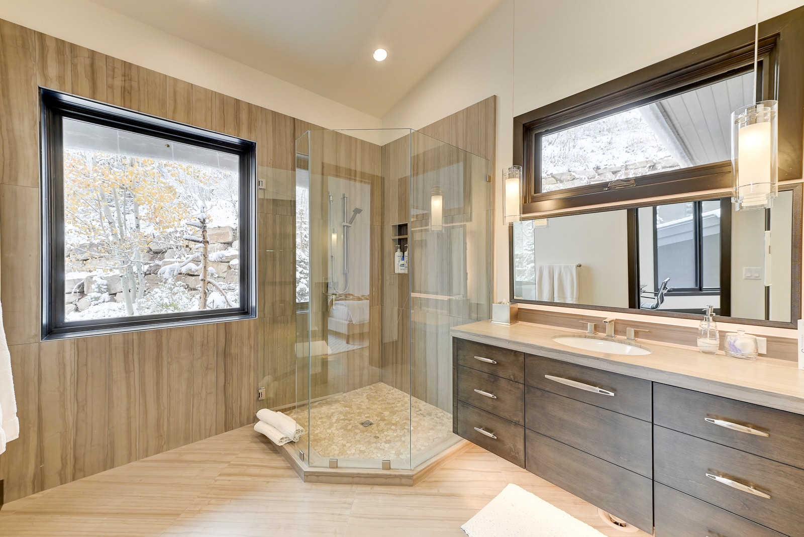 Attached bath includes statement vanity, full shower, and storage.