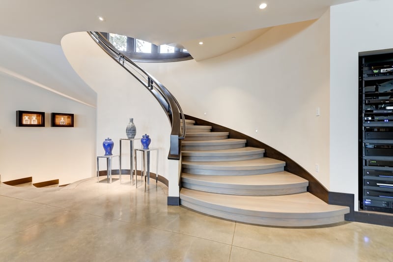 Flowing staircase to the lower family and game area.