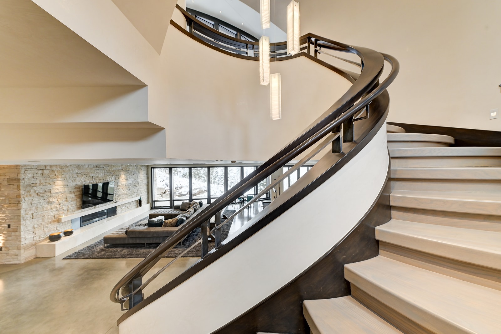 Floating stair and curved banister define the home’s central vertical flow.