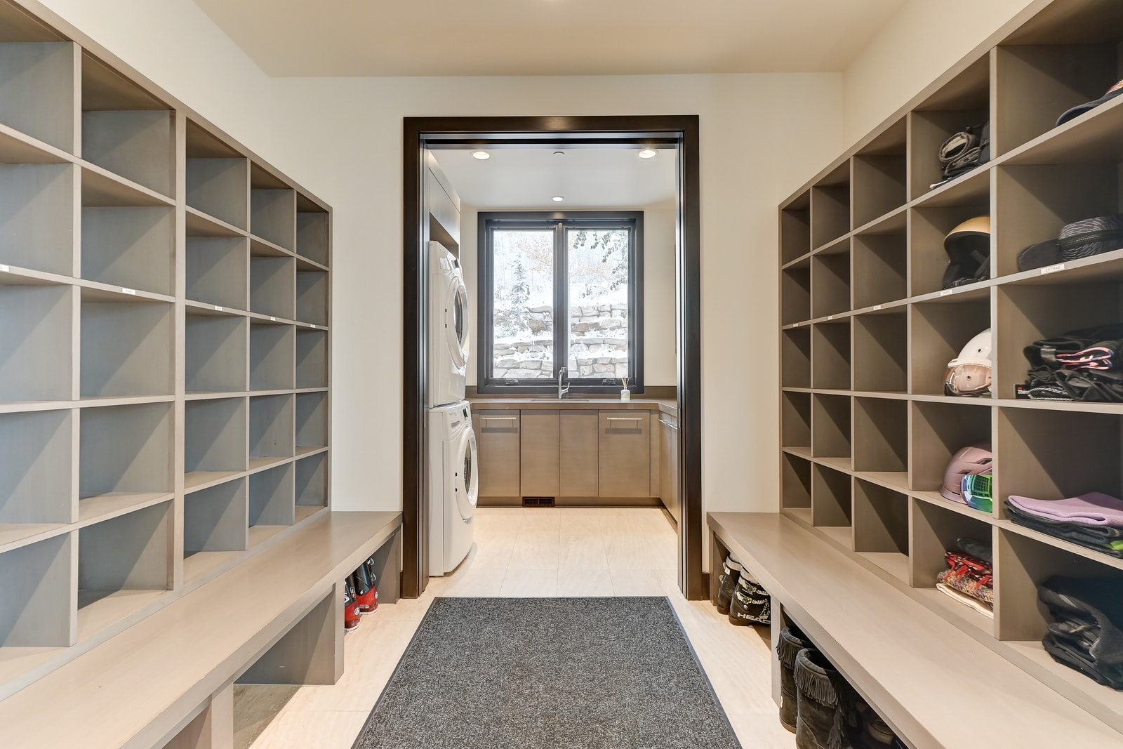 Boots and coats stay tidy in this extra-large gear room with bench seating.