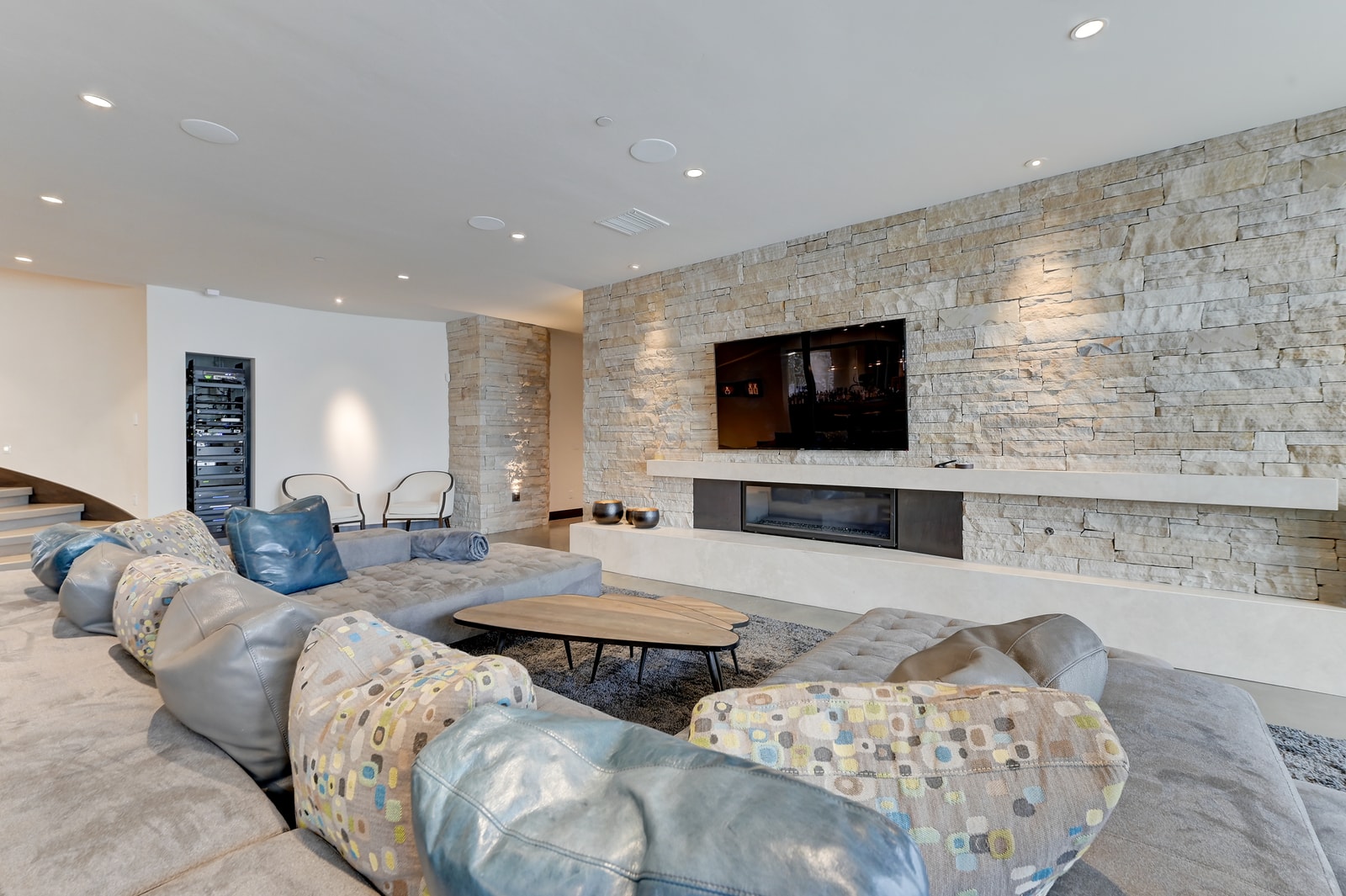 Cozy lounge area with fireplace and large-screen TV for group relaxation.