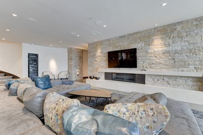 Cozy lounge area with fireplace and large-screen TV for group relaxation. PCO-184M