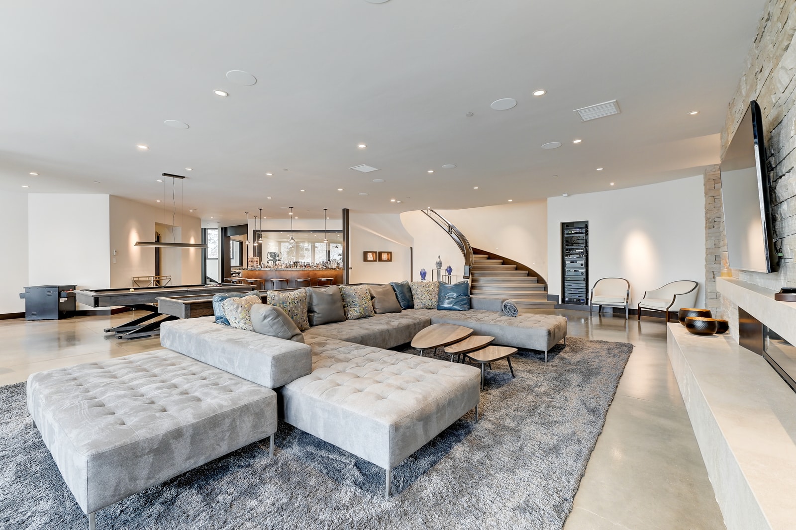 Downstairs family room with huge sectional and bar seating for game nights.