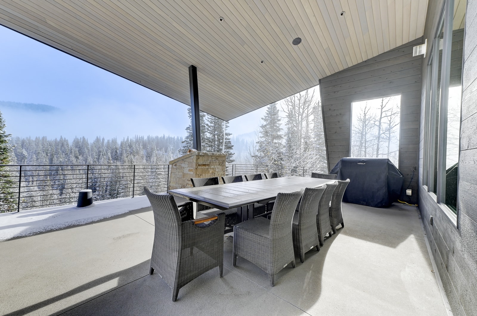 Covered patio with dining setup just outside the main living area.