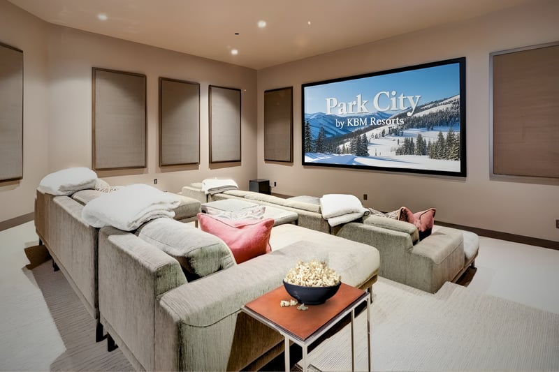 Dedicated theater with tiered seating and oversized screen for movie nights at home.