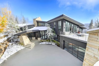 Stone entry drive and modern architecture create a dramatic first impression. PCO-184M