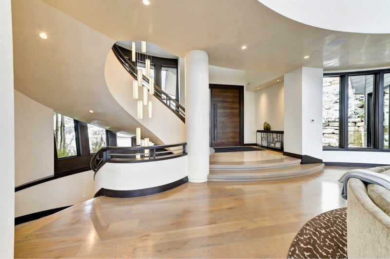 Elegant curved staircase welcomes you into the light-filled main level. PCO-184M