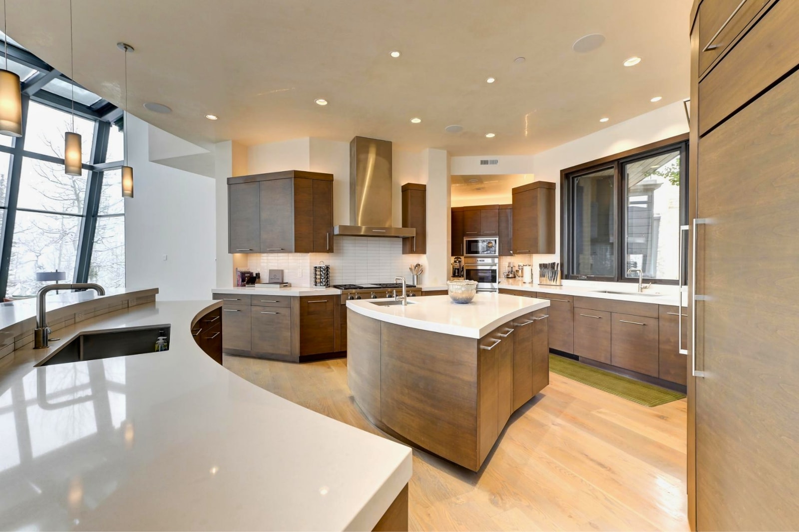 Curved island seating offers a casual spot for breakfast or cocktails.