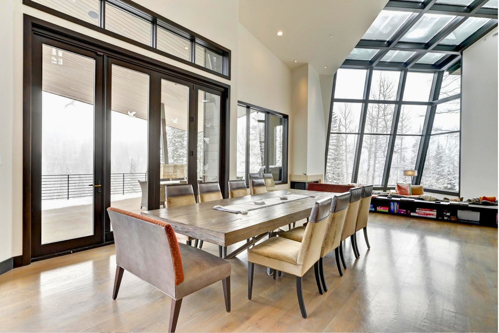 Wall-to-wall windows and seamless flow to the balcony define this luxe dining area.