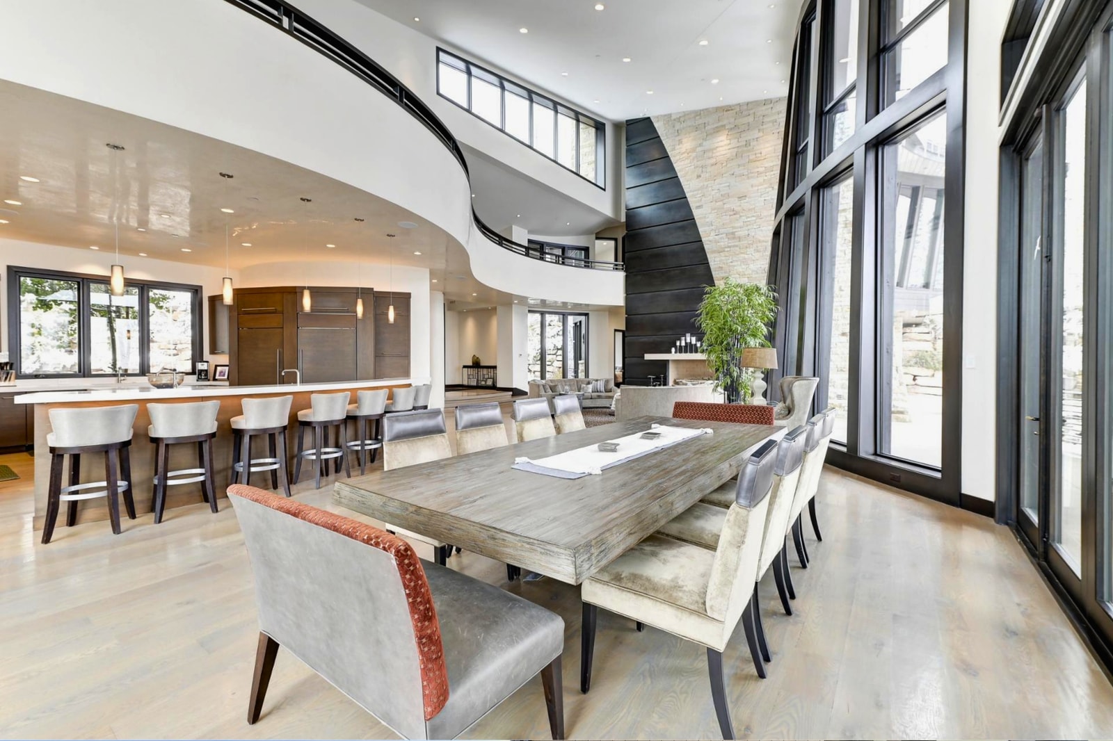 Gather around a custom live-edge table beneath dramatic architecture and natural light.