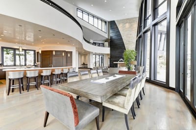 Gather around a custom live-edge table beneath dramatic architecture and natural light. PCO-184M