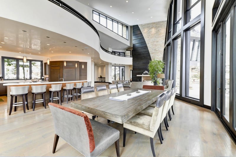Gather around a custom table beneath dramatic architecture and natural light.
