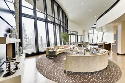 Vaulted ceilings, fireplace, and mountain views create a stunning space to connect. PCO-184M
