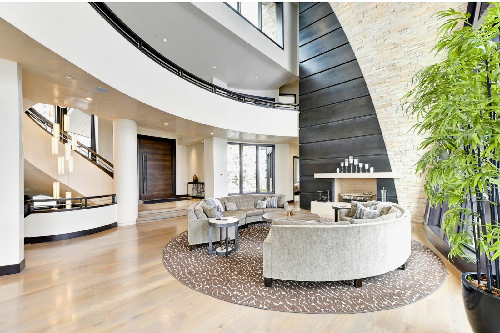 Open living room with layered textures, large windows, and contemporary comfort.