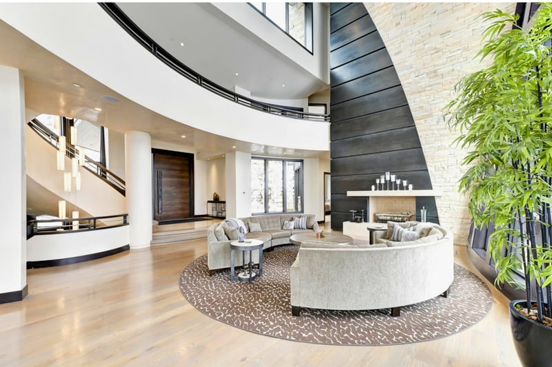Open living room with layered textures, large windows, and contemporary comfort.