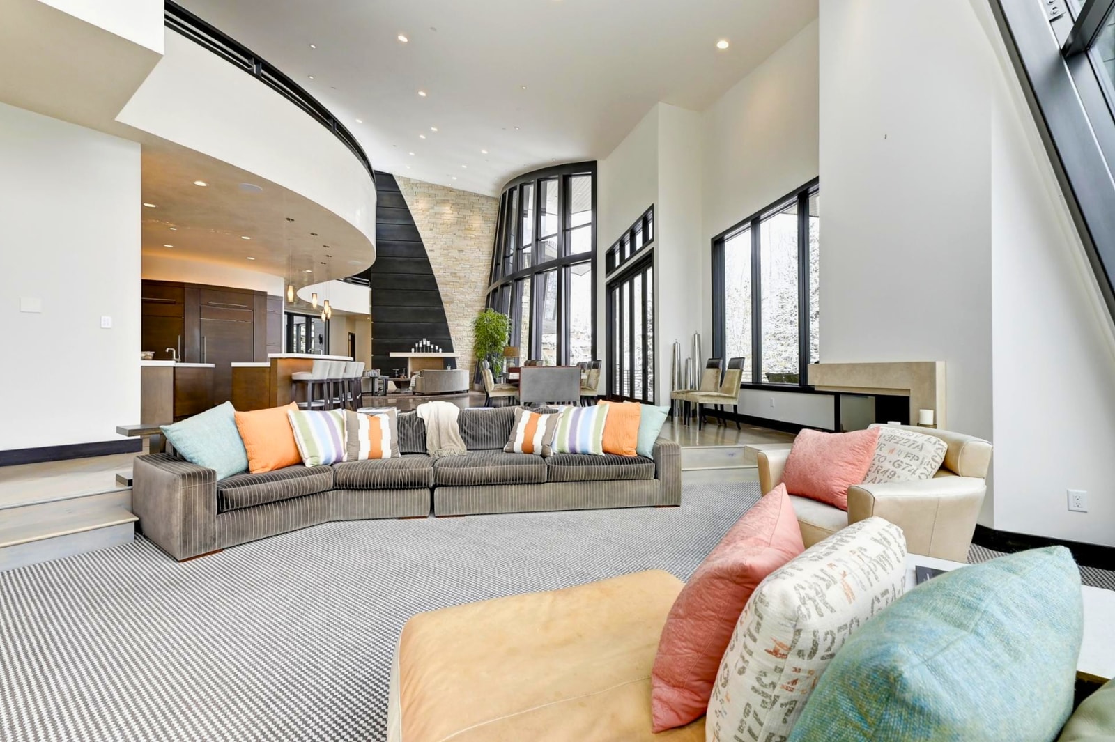 Colorful cushions and oversized sofas provide a laid-back feel in the secondary living area.