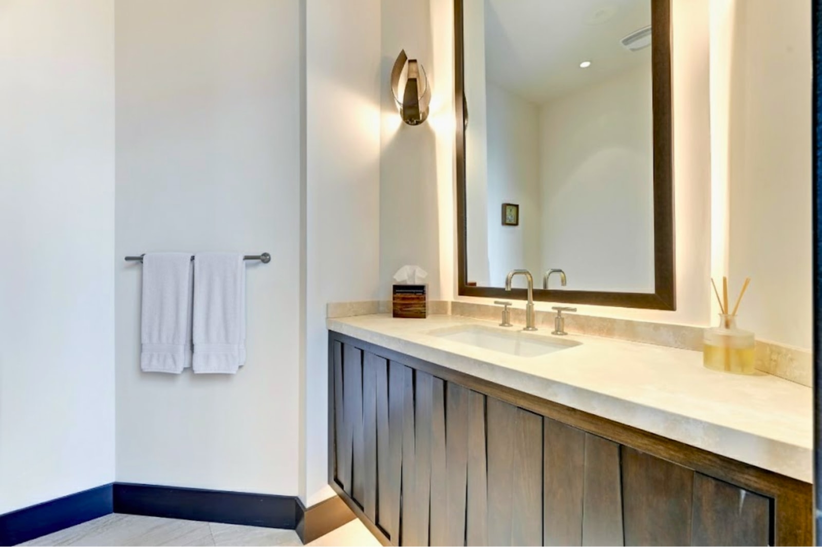 Main-level powder room with elegant vanity and statement lighting.