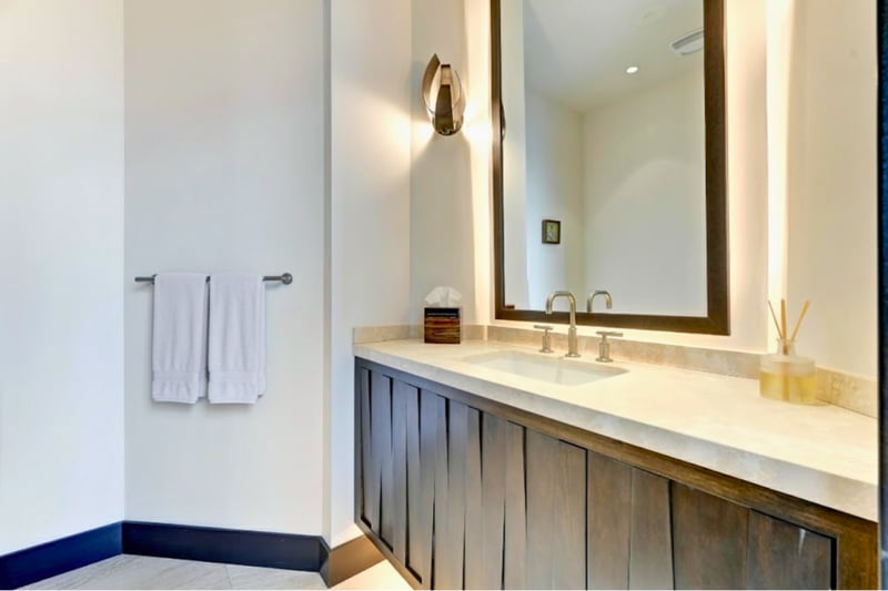 Main-level powder room with elegant vanity and statement lighting.