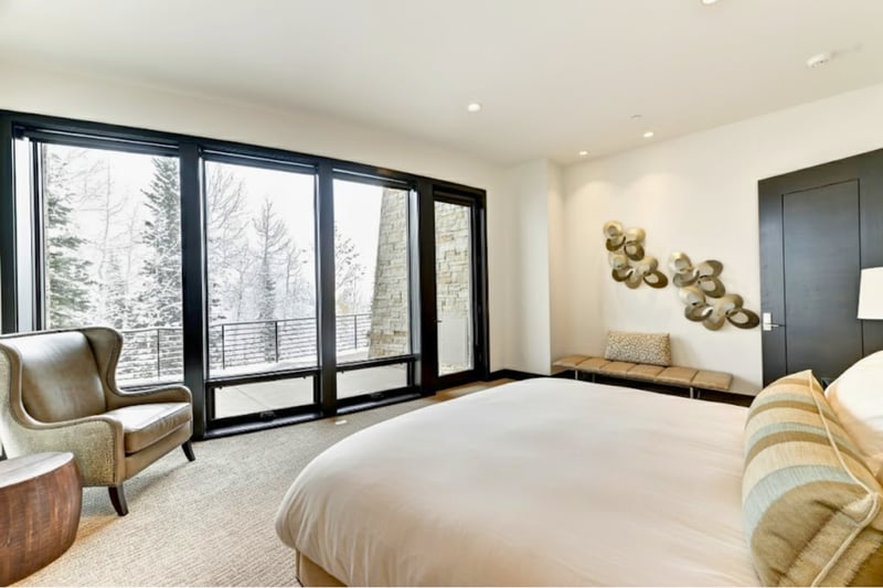 Wake to mountain tree views through your wall of windows in this peaceful suite.