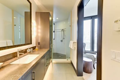 Spa-style ensuite with dual vanity, rain shower, and soaking tub. PCO-184M