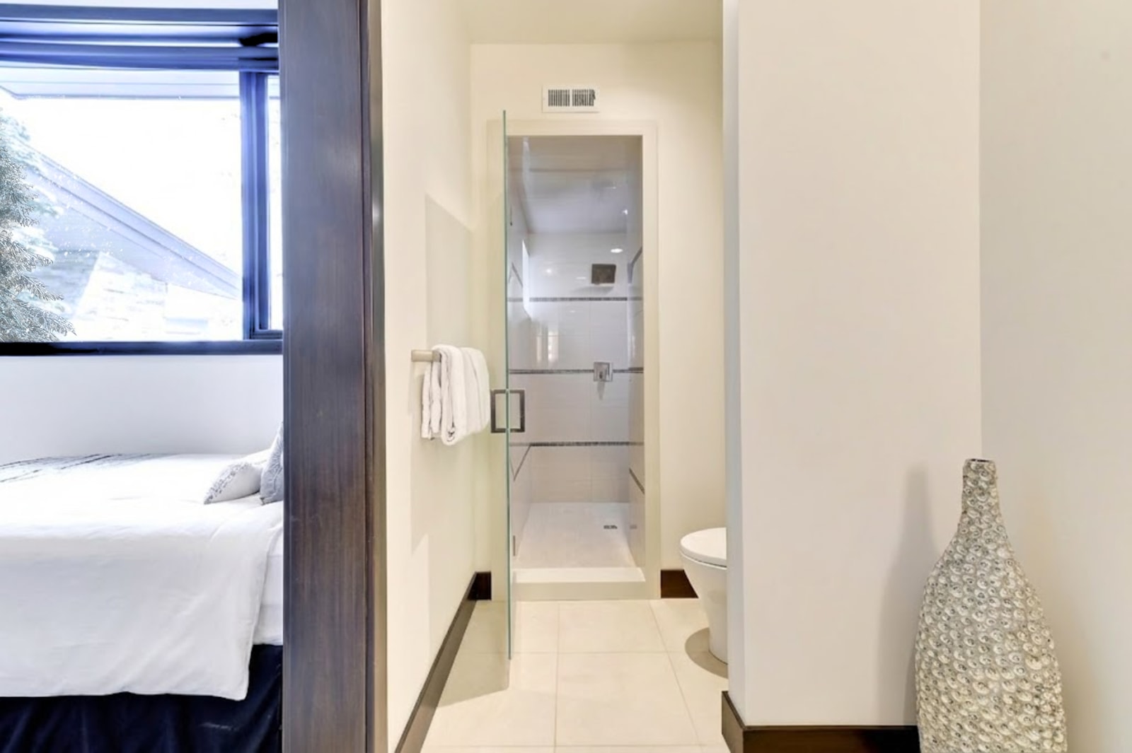 Full bath with walk-in shower and elegant tilework.