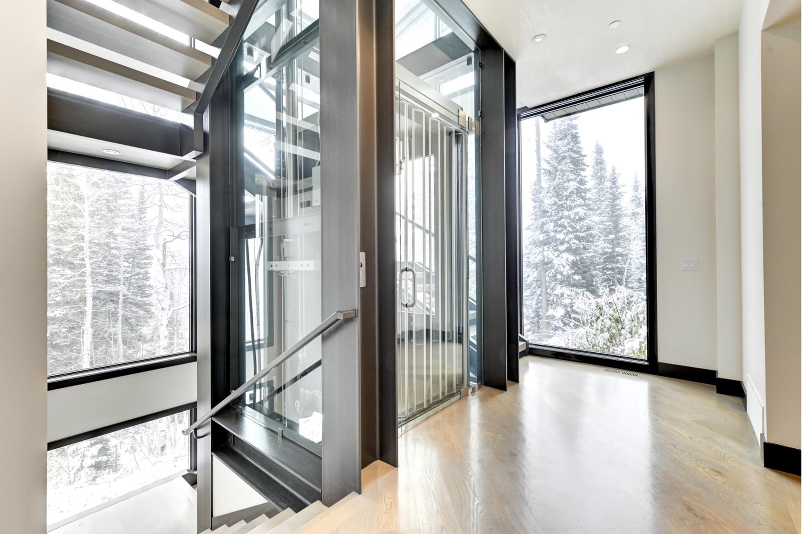 Glass elevator and floating staircase connect three stunning levels.