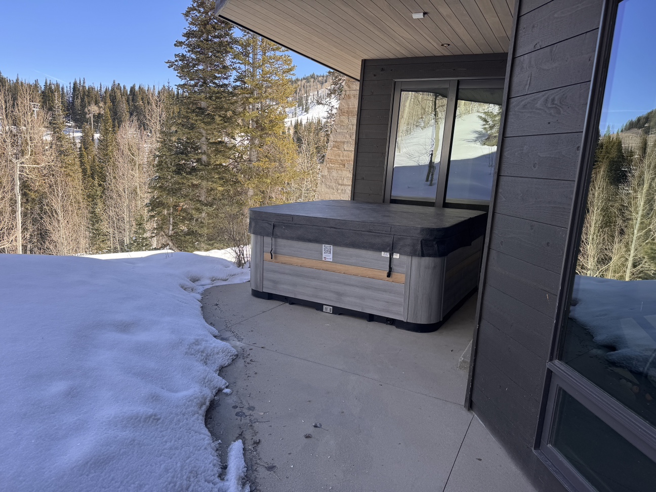 Step outside after working out and relax in the covered hot tub  - relish the views! 