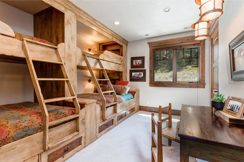 This spacious bunk room sleeps six and includes a game table and built-ins.