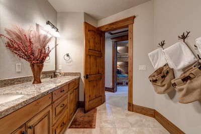Double vanity and granite counters offer comfort for shared use.