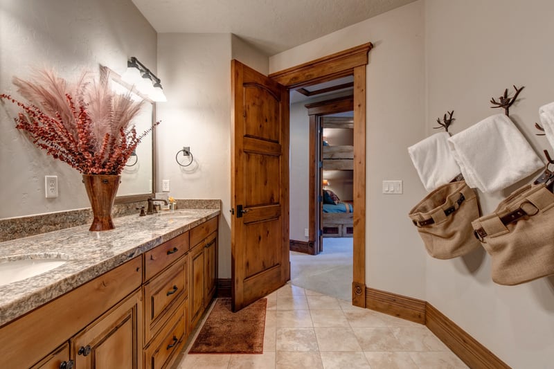 Double vanity and granite counters offer comfort for shared use.