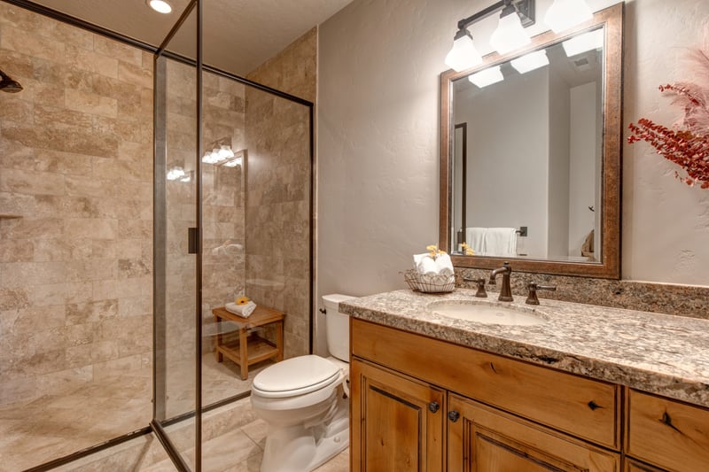 This shared bath includes a walk-in shower and full amenities.