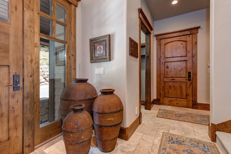 The home’s entry greets you with mountain charm, natural textures, and lodge-style finishes.