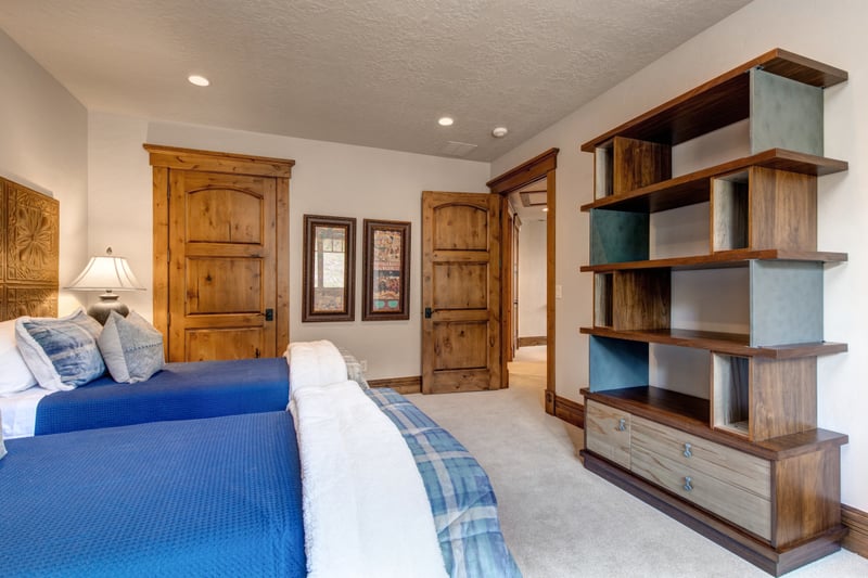 Upper-level room with twin beds and generous closet space for families or singles.