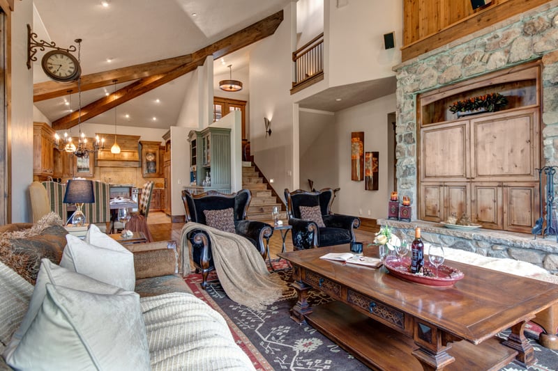 Vaulted ceilings and hardwood floors extend from the great room to the dining area beyond.