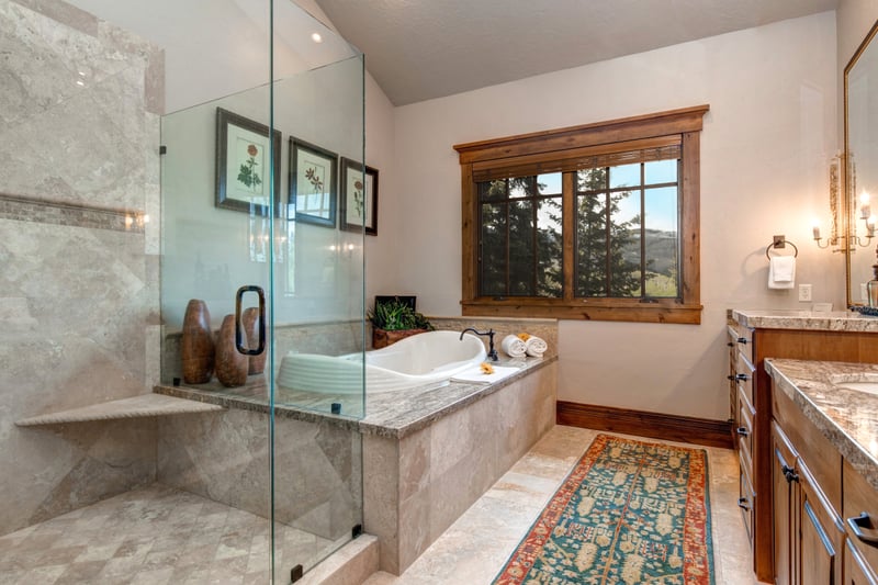 Your en suite bath offers a soaking tub, walk-in shower, and tree views.