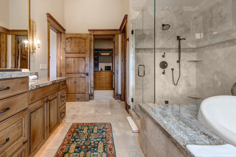 Granite counters, custom cabinetry, and spa-style layout make this bath a true retreat.