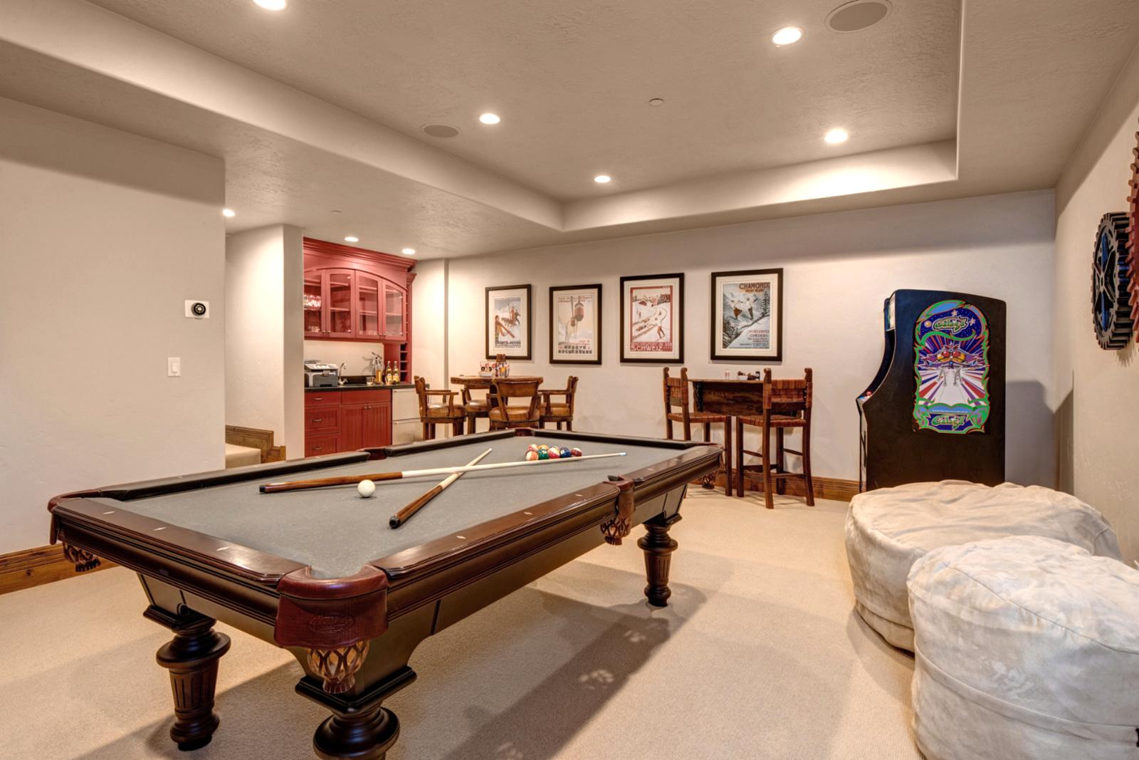 Recreation lounge includes arcade-style games and cozy seating.