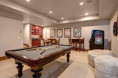 Recreation lounge includes arcade-style games and cozy seating.