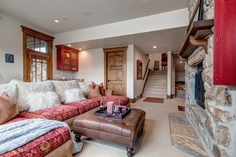 Lower-level family room opens to additional sleeping quarters and outside hot tub