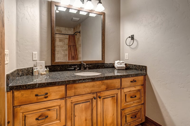 Granite vanity and generous storage make this full bath both stylish and functional.